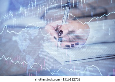 Multi exposure of hands making notes with forex chart huds. Stock market concept.