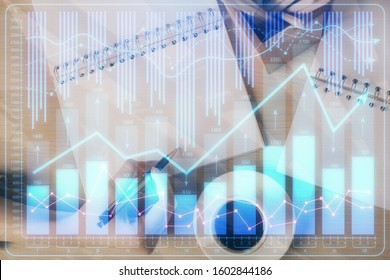 Multi exposure of hands making notes with forex chart huds. Stock market concept. - Shutterstock ID 1602844186
