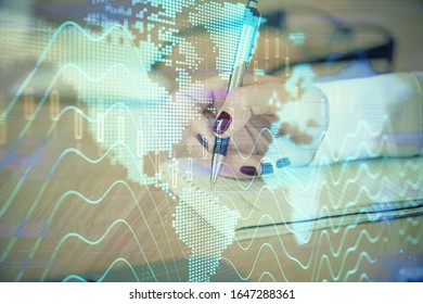 Multi exposure of hands making notes with forex chart huds. Stock market concept.