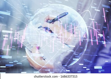 Multi exposure of hands making notes with forex chart huds. Stock market concept.