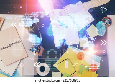 Multi exposure of hands making notes with world map hologram and data theme icons. Concept of global computer data.