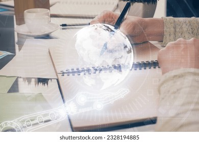 Multi exposure of hands making notes with world map hologram and data theme icons. Concept of global computer data.
