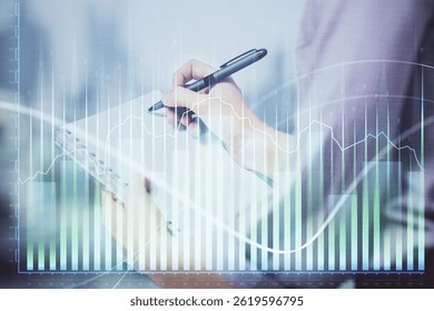 Multi exposure of hands making notes with forex chart huds. Stock market concept.