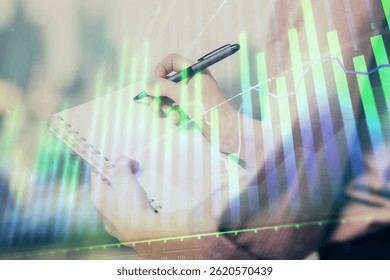 Multi exposure of hands making notes with forex chart huds. Stock market concept.