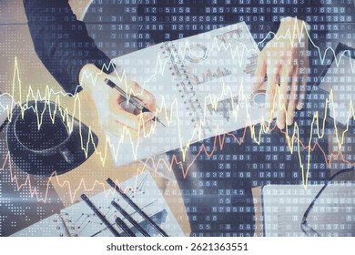 Multi exposure of hands making notes with forex chart huds. Stock market concept.