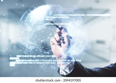 Multi exposure of programmer's hand with pen working with abstract graphic coding sketch and world map on blurred office background, big data and networking concept