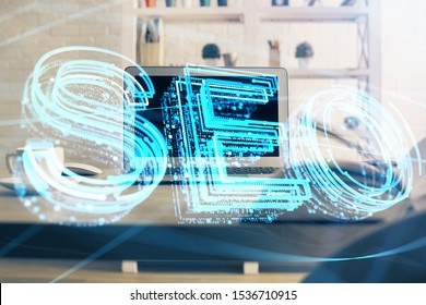 Multi exposure of table with computer and seo drawing hologram. Search optimization concept.