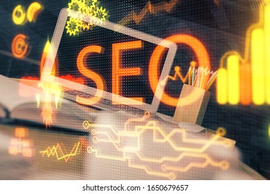 Multi exposure of table with computer and seo drawing hologram. Search optimization concept.