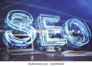 Multi exposure of table with computer and seo drawing hologram. Search optimization concept.