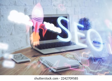 Multi exposure of table with computer and seo drawing hologram. Search optimization concept. - Shutterstock ID 2242709585