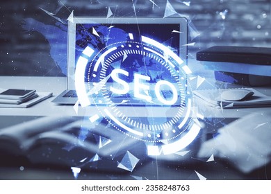 Multi exposure of table with computer and seo drawing hologram. Search optimization concept.