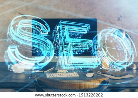 Multi exposure of table with computer and seo drawing hologram. Search optimization concept.