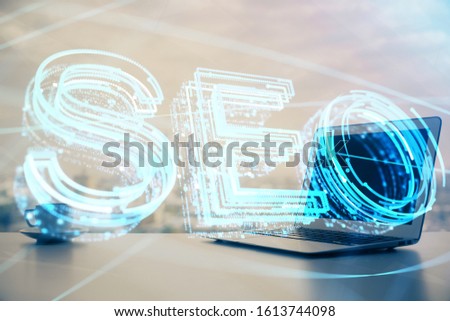 Multi exposure of table with computer and seo drawing hologram. Search optimization concept.