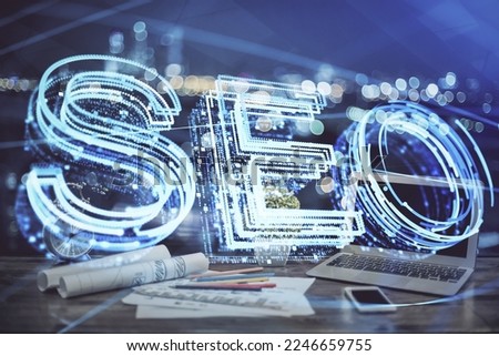 Multi exposure of table with computer and seo drawing hologram. Search optimization concept.