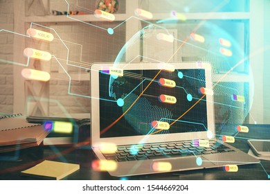 Multi exposure of table with computer and world map hologram. International data network concept.