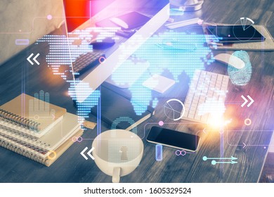 Multi exposure of table with computer and world map hologram. International data network concept.