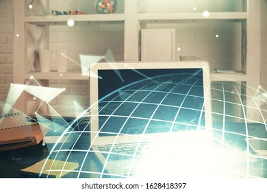 Multi exposure of table with computer and world map hologram. International data network concept.