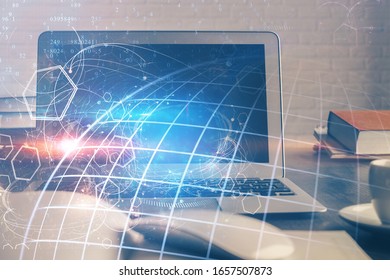 Multi exposure of table with computer and world map hologram. International data network concept.