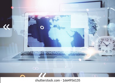 Multi exposure of table with computer and world map hologram. International data network concept.
