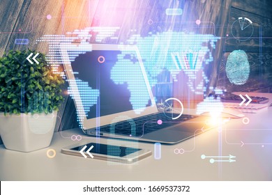 Multi exposure of table with computer and world map hologram. International data network concept.