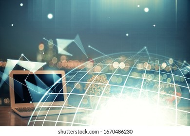 Multi exposure of table with computer and world map hologram. International data network concept.