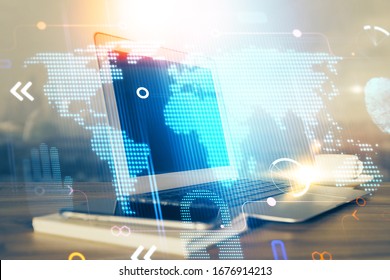 Multi exposure of table with computer and world map hologram. International data network concept.