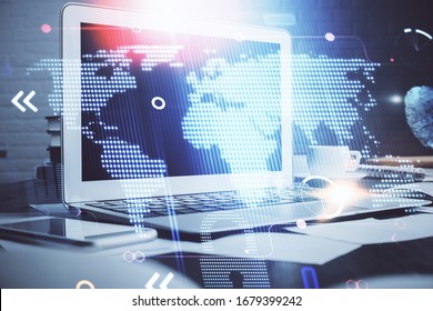 Multi exposure of table with computer and world map hologram. International data network concept.