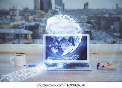Multi exposure of table with computer and world map hologram. International data network concept.