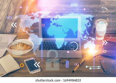 Multi exposure of table with computer and world map hologram. International data network concept.