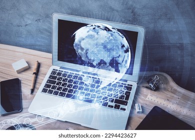 Multi exposure of table with computer and world map hologram. International data network concept.