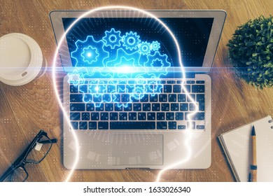 Multi exposure of work table with computer and brain hologram. Brainstorm concept.