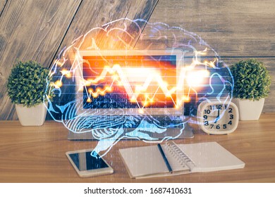 Multi exposure of work table with computer and brain hologram. Brainstorm concept.