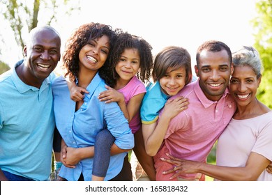 Multi Generation African American Family Standing In Garden