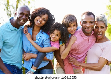 Multi Generation African American Family Standing In Garden