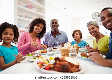 Multi Generation African American Family Eating Meal At Home