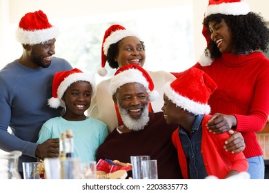 Multi generation african american family smiling and wearing santa hats. quality family time christmas celebration. - Powered by Shutterstock