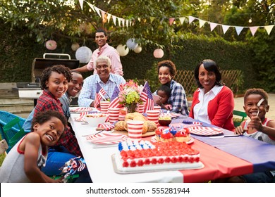 Multi generation black family having a 4th July garden party - Powered by Shutterstock