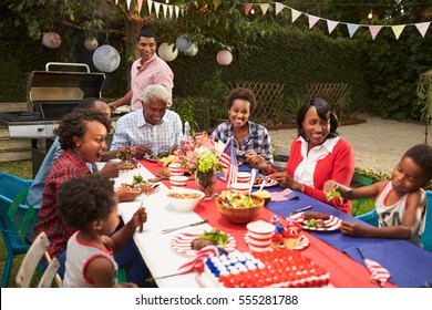Multi Generation Black Family At Table For 4th July Barbecue