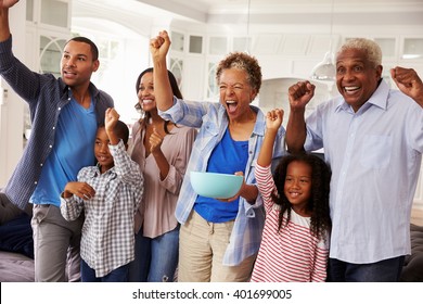 Multi Generation Black Family Watching Sport On TV Celebrate