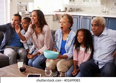 Multi Generation Black Family Watching Sport On TV At Home