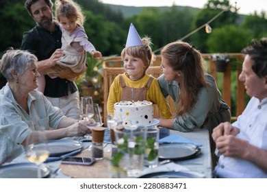 Multi generation family celebrating birthday and have garden party outside in the backyard on patio. - Powered by Shutterstock