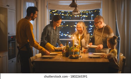 Multi Generation Family Of Celebrating Together, Gathering Around The Table With Delicious Dinner Meal. Young Mother Takes Dish Out Of Oven Grandparents Admire How Delicious Casserole Looks