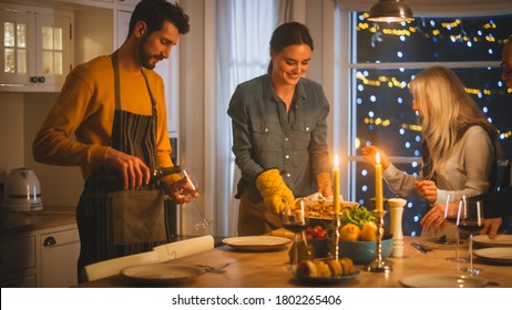 Multi Generation Family Of Celebrating Together, Gathering Around The Table With Delicious Dinner Meal. Young Mother Takes Dish Out Of Oven Grandparents Admire How Delicious Casserole Looks