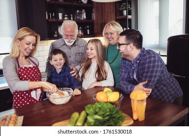 Multi Generation Family Cooking Meal At Home