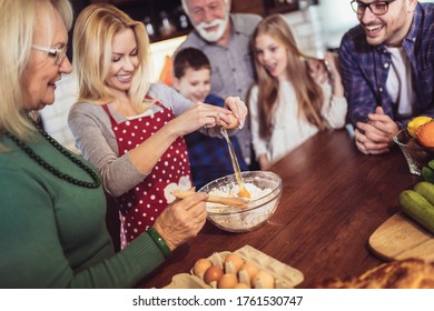 Multi Generation Family Cooking Meal At Home