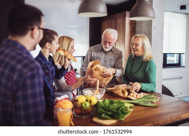 Multi Generation Family Cooking Meal At Home