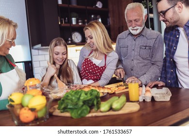 Multi Generation Family Cooking Meal At Home