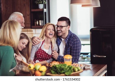 Multi Generation Family Cooking Meal At Home