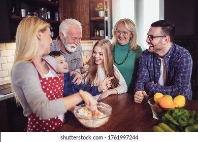 Multi Generation Family Cooking Meal At Home