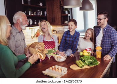 Multi Generation Family Cooking Meal At Home